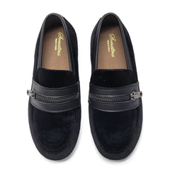 Pair of black loafers with a zipper detail on a white background