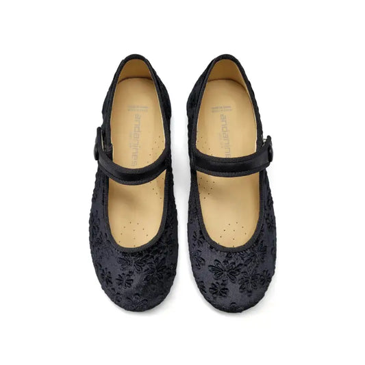 Black floral-patterned shoes with a strap on a white background