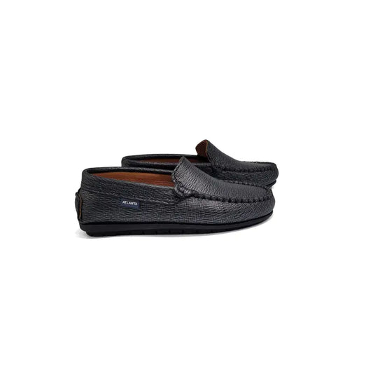 Pair of black shimmer moccasin slippers on a white background