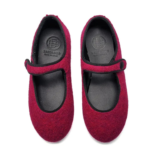 Pair of fuchsia mary jane with black soles on a white background