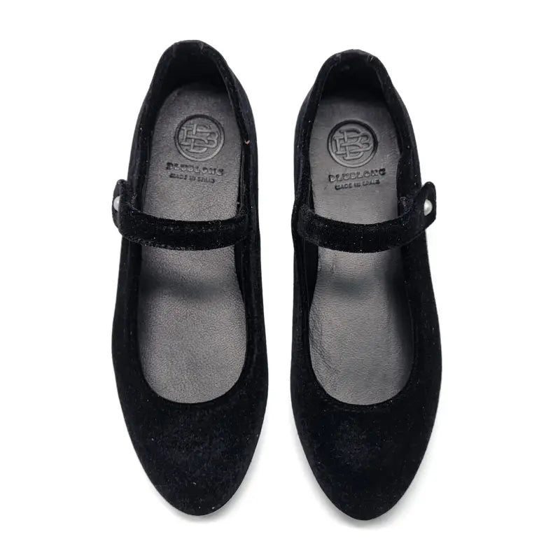 Pair of black shoes with a visible brand logo on a white background