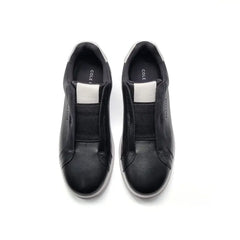 Black slip-on shoes with 'Cole' branding on a white background