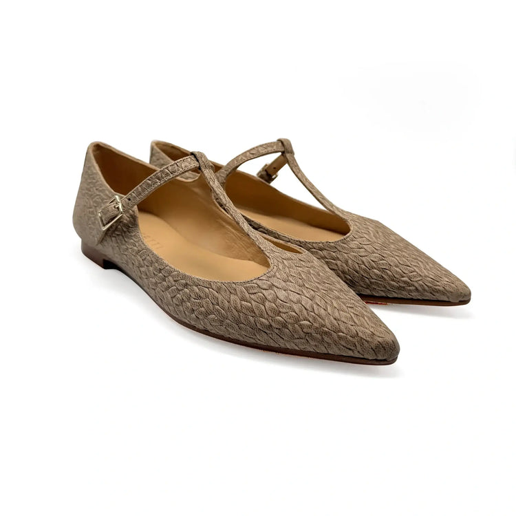 Pair of brown textured flats with a strap on a white background