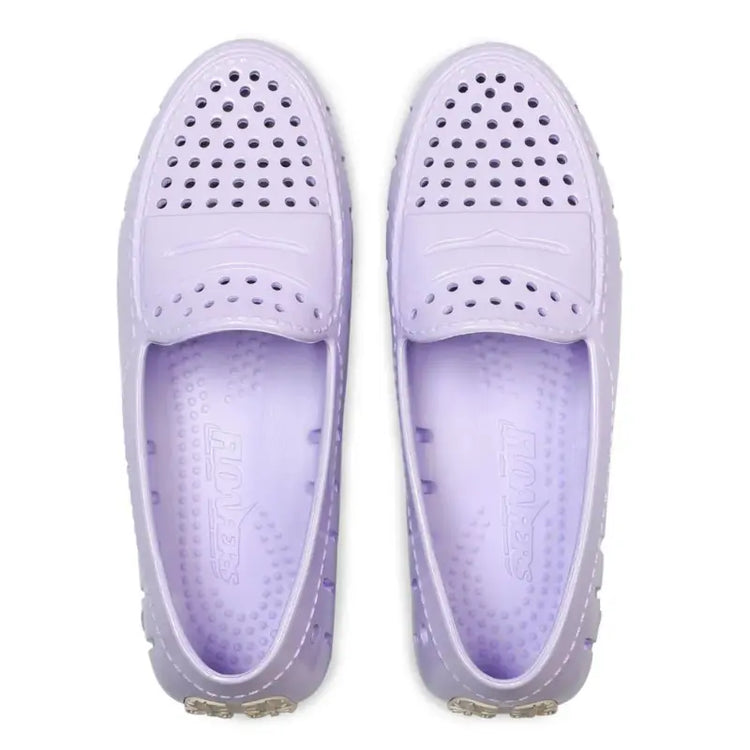 Pair of lavender shoes with holes on a white background