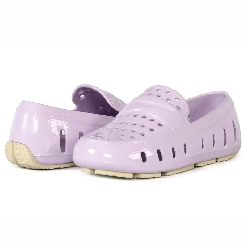 Pair of lavender clogs on a white background