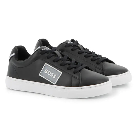 Black sneakers with a visible 'BOSS' logo on a white background