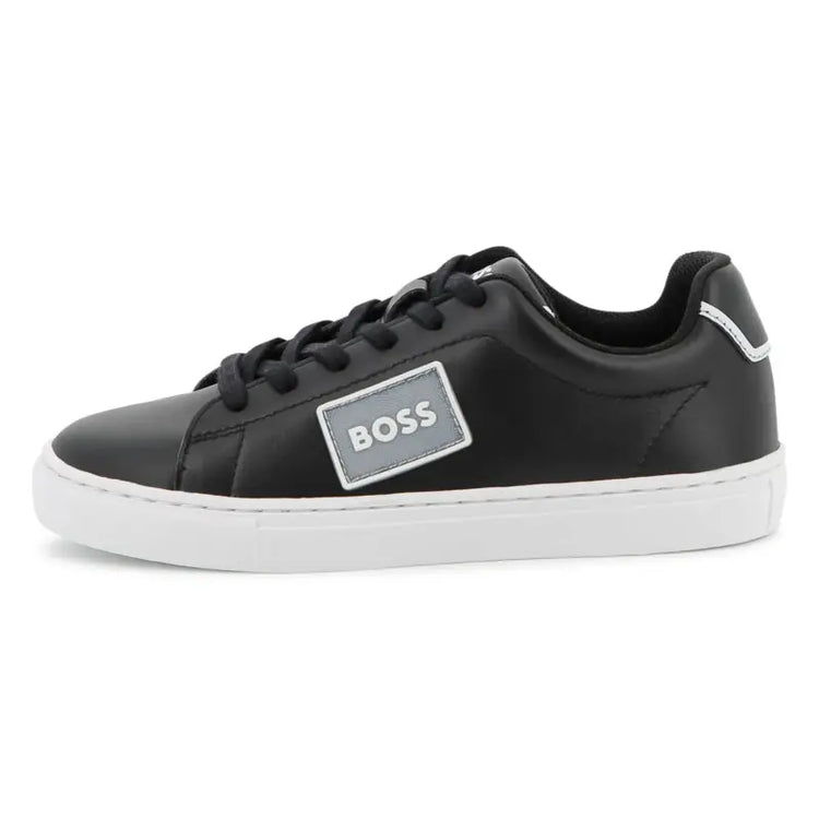 Black sneaker with a 'BOSS' logo on a white background