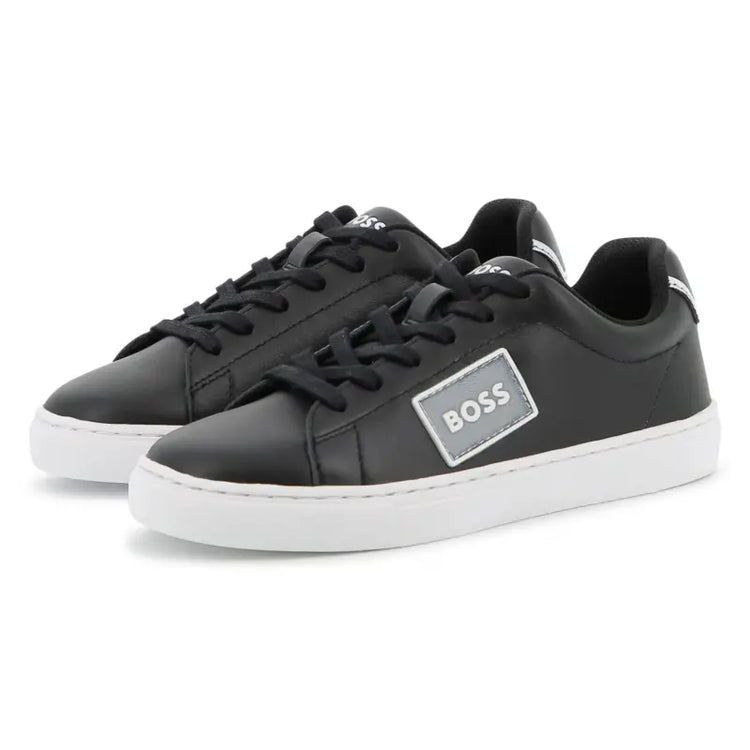 Black sneakers with a visible brand logo on a white background