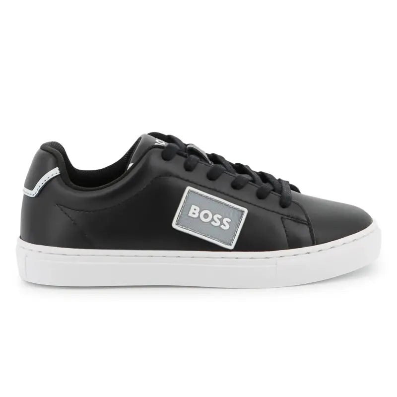 Black sneaker with 'BOSS' logo on a white background