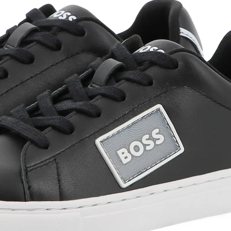 Black sneakers with a BOSS logo on a white background