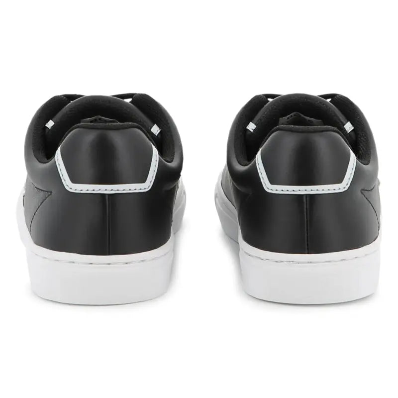 Black sneakers with white soles on a white background