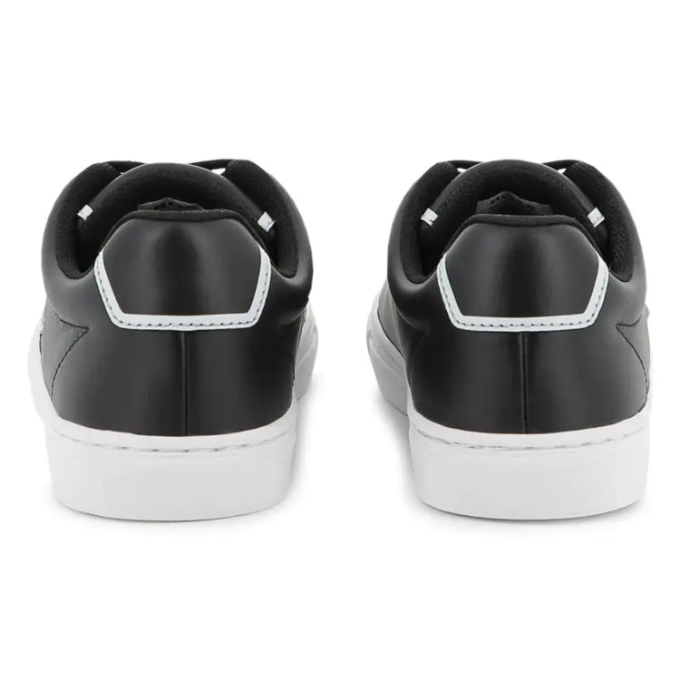 Black sneakers with white soles on a white background