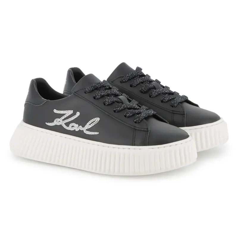 Black sneakers with white sole on a white background