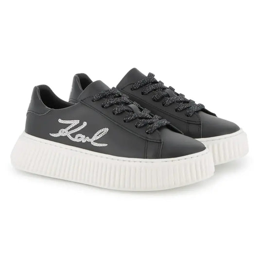Black sneakers with white sole on a white background