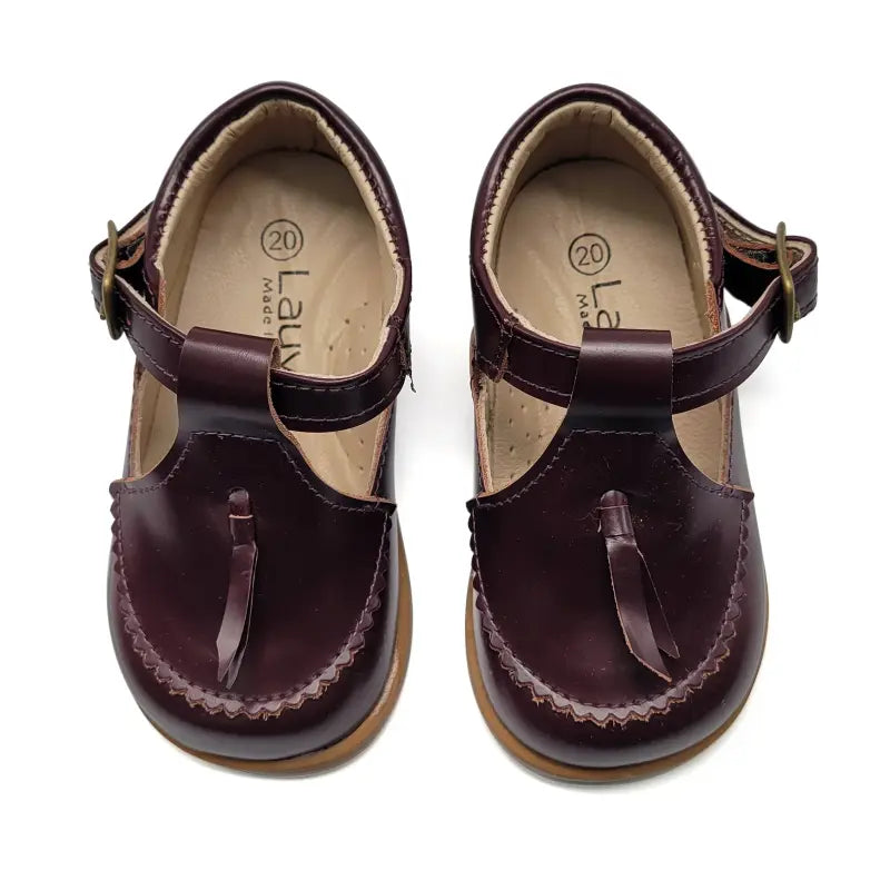 Pair of brown children's sandals with a strap on a white background