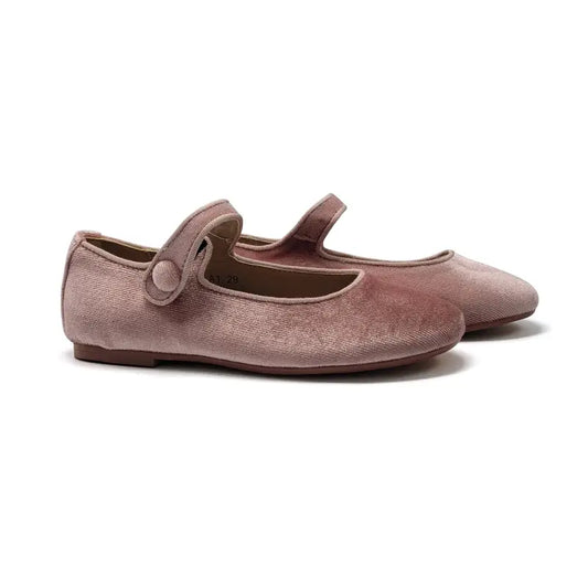 Pair of pink velvet shoes with a strap on a white background