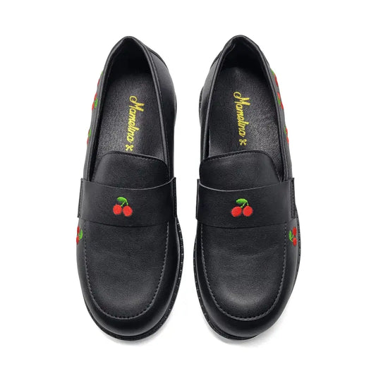 Black loafers with cherry designs on a white background