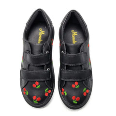 Black shoes with cherry designs on a white background