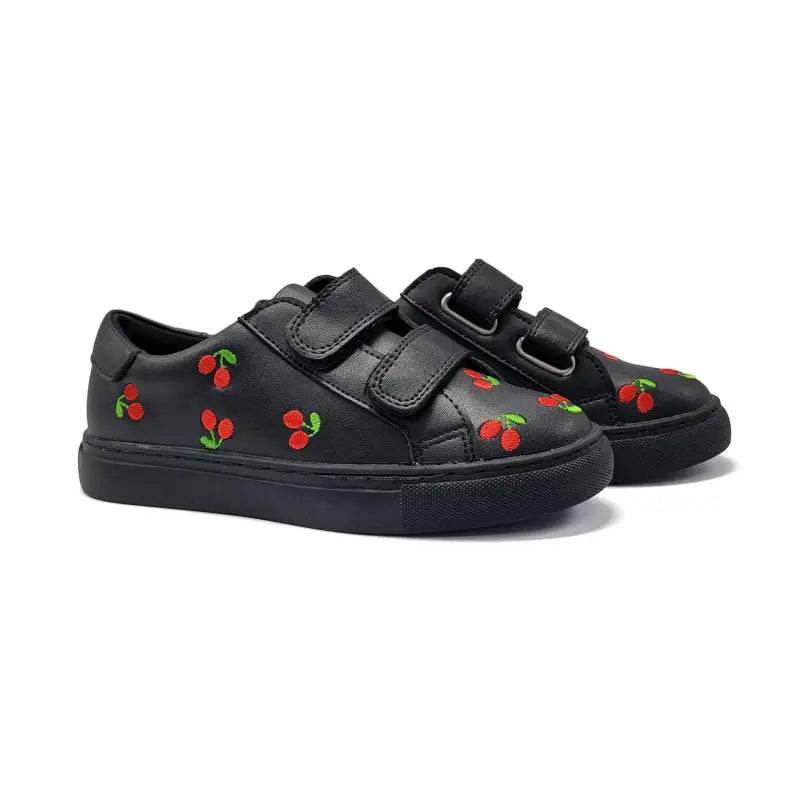 Black sneakers with cherry designs on a white background