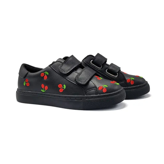 Black sneakers with cherry designs on a white background