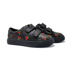 Black sneakers with cherry designs on a white background