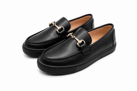 A pair of black leather loafer-style shoes with gold-tone horsebit hardware, shown on a clean white background.