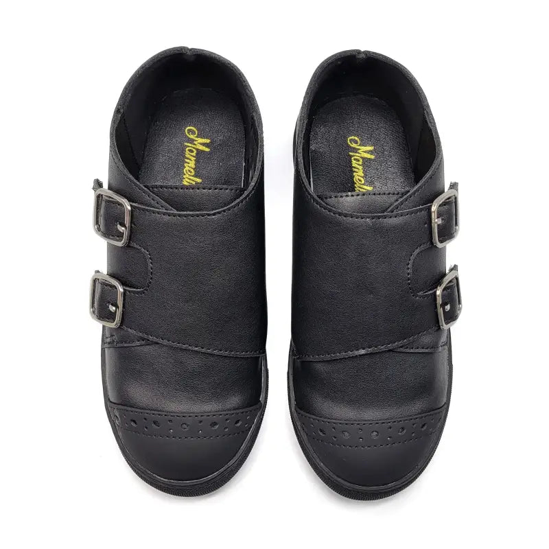 Pair of black shoes with buckles on a white background
