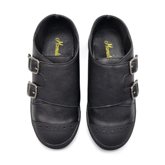 Pair of black shoes with buckles on a white background