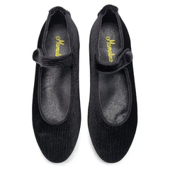Pair of black shoes with a strap on a white background
