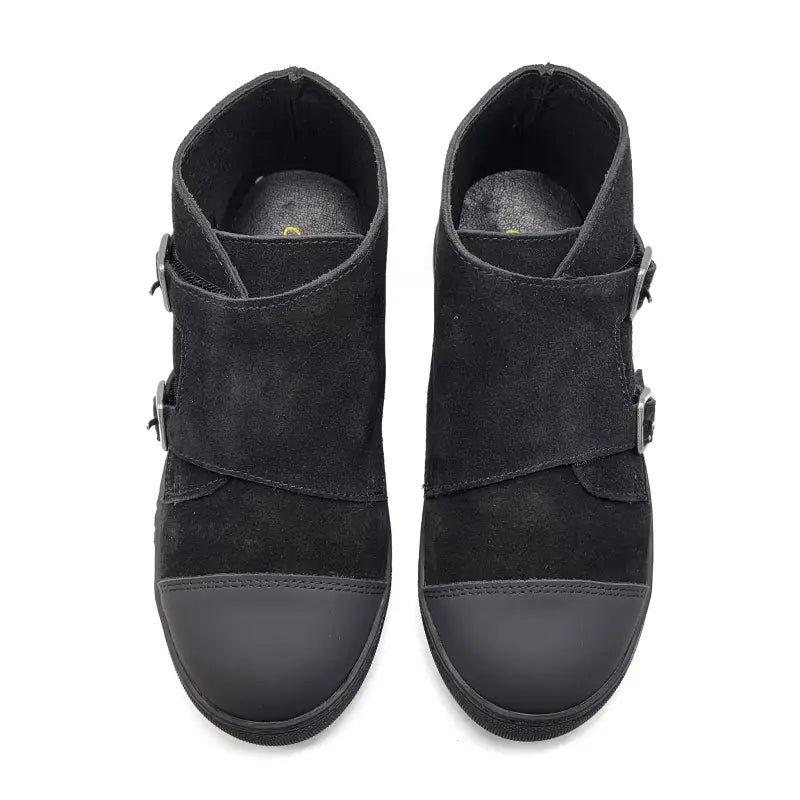 Pair of black suede ankle boots with buckles on a white background