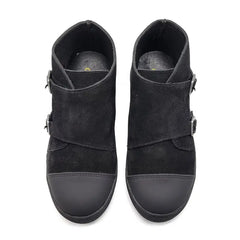 Pair of black suede ankle boots with buckles on a white background