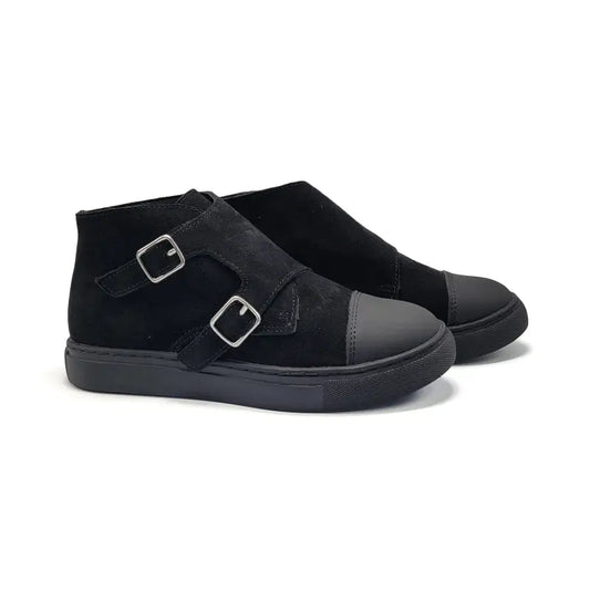 Black suede shoes with buckle details on a white background