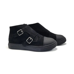 Black suede shoes with buckle details on a white background