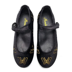 Black shoes with gold butterfly designs on a white background