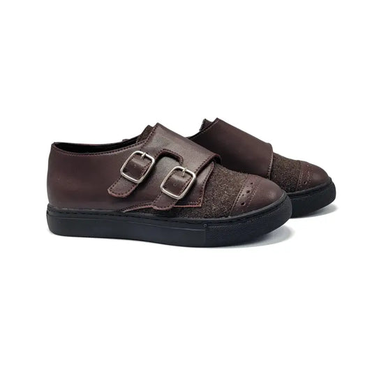 Pair of brown shoes with double buckles on a white background