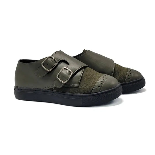 Pair of green shoes with buckles on a white background