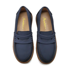 Pair of blue loafers with brown soles on a white background