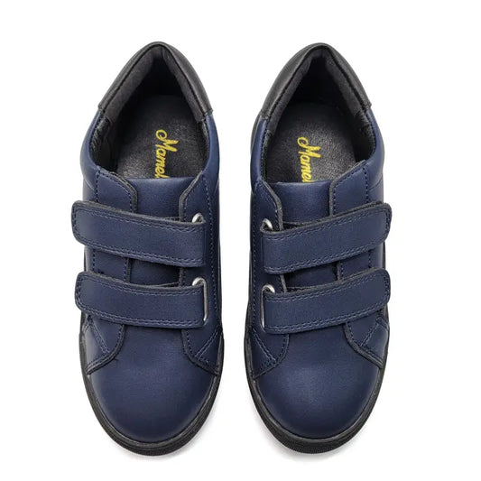Pair of blue children's shoes with velcro straps on a white background