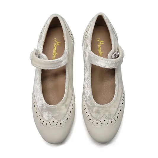 Pair of white shoes with a strap on a white background
