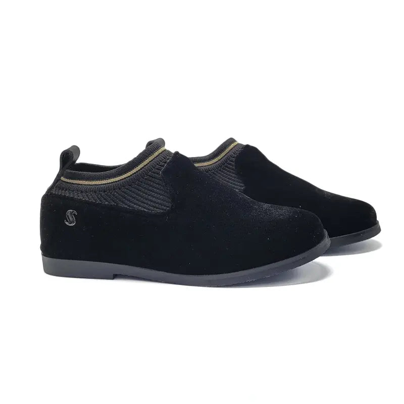 Pair of black slip-on shoes on a white background